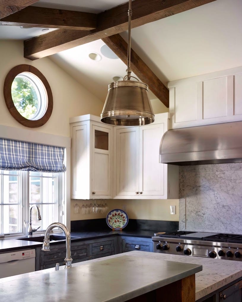 Crisp white kitchen with hood and patterned window valance