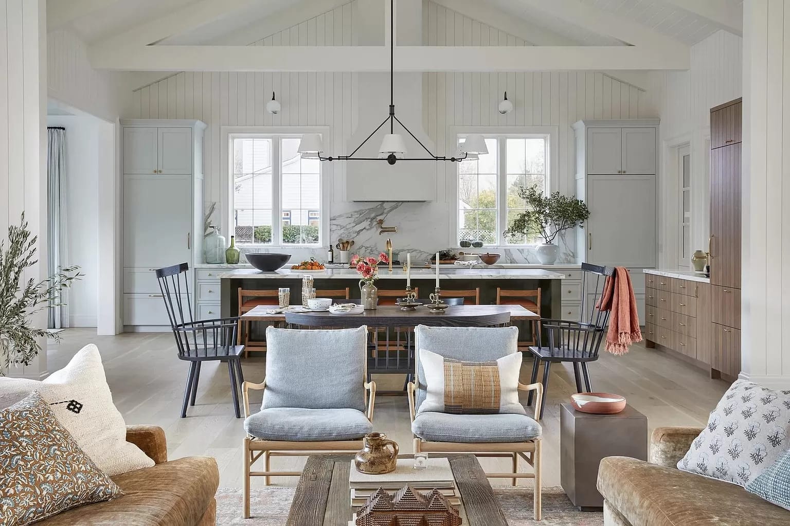 Open-plan white kitchen flowing into the dining area