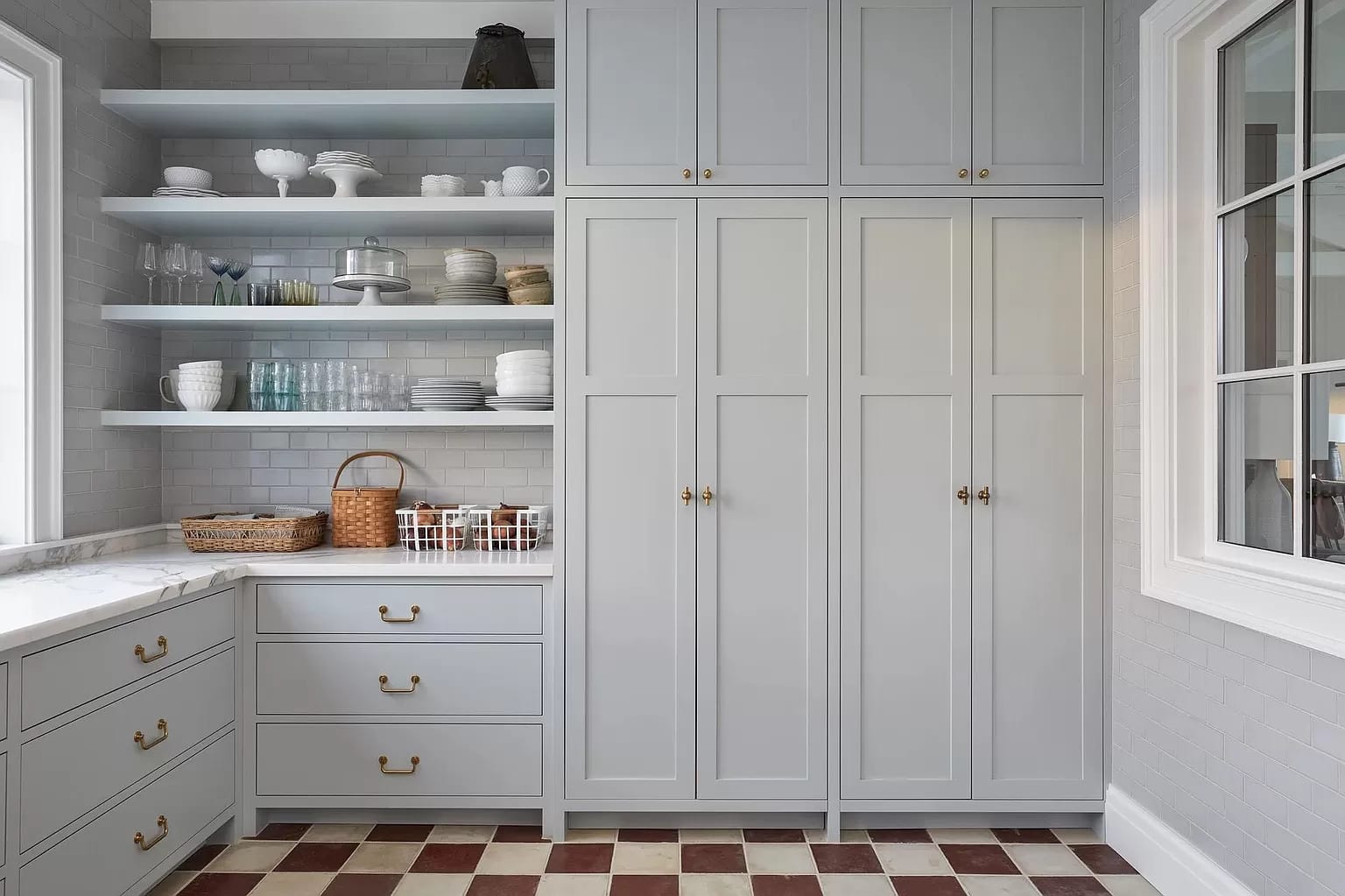 Floor-to-ceiling white cabinetry with glass uppers