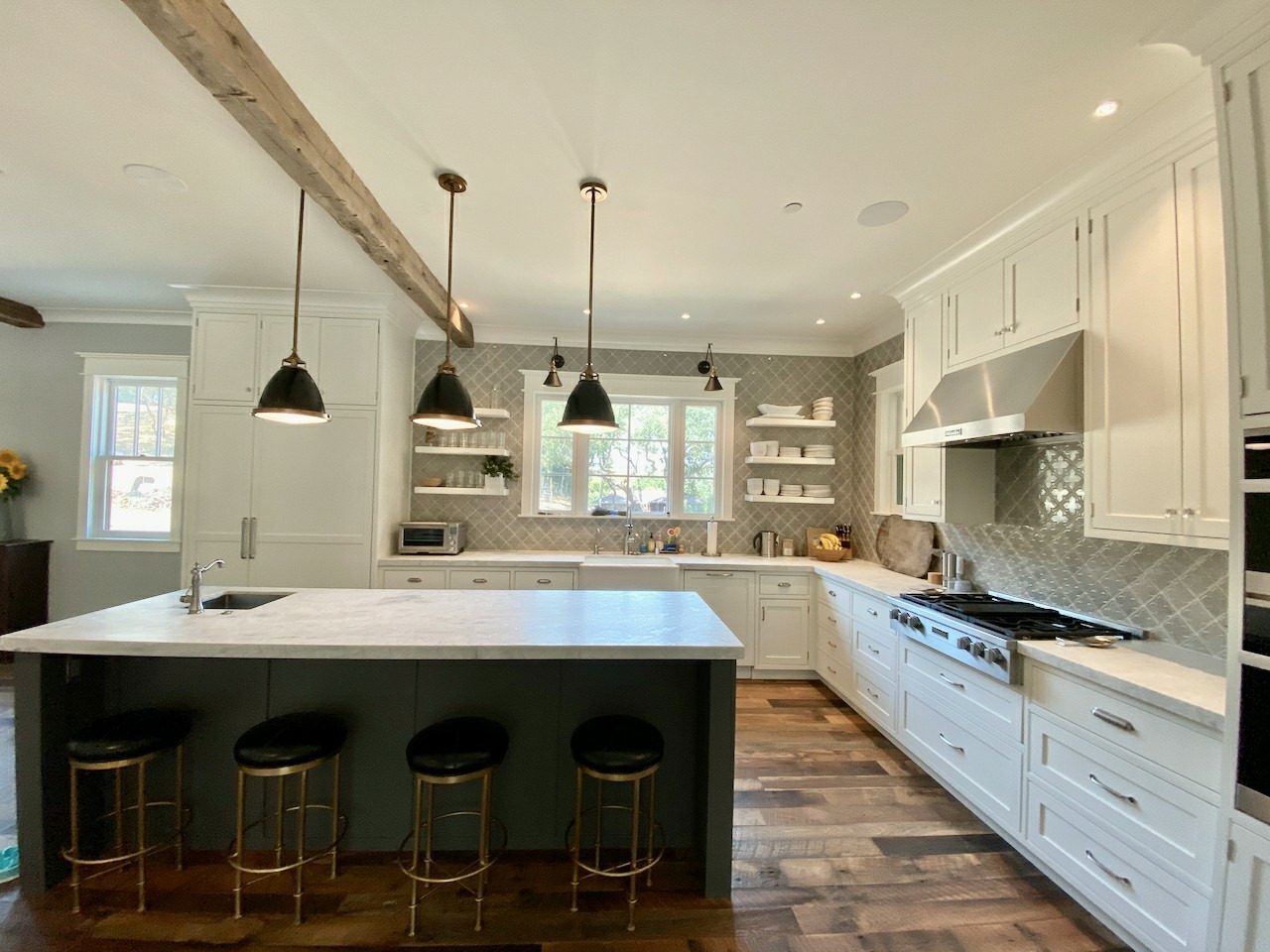 Deep-green painted island in a white kitchen