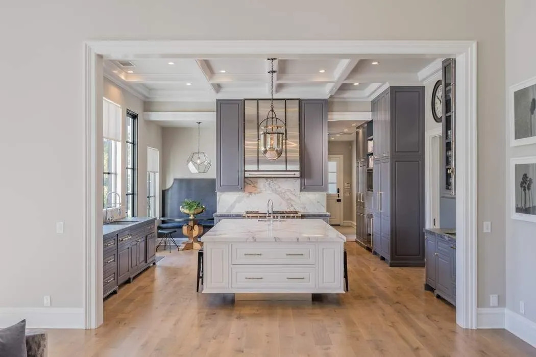 Refinished gray-and-white kitchen with a marble island